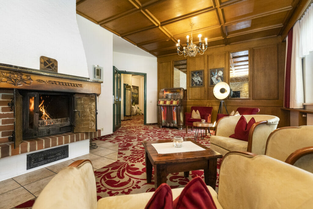Lounge with fireplace in Hotel Pongauerhof